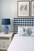 Classic navy lampshade creating warm ambient lighting in a living room
