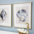 Navy and gold-toned scallop shell print in a gold-toned bamboo-look frame with pale surround