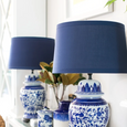 Navy drum lampshade styled on a table lamp in a Hamptons-inspired bedroom