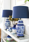 Navy drum lampshade styled on a table lamp in a Hamptons-inspired bedroom