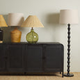 Elegant black and natural floor lamp for living room or reading nook lighting.