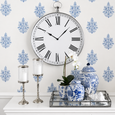 Northampton Wall Clock Silver White styled above coastal console with blue and white ginger jars, orchid arrangement, silver candle holders, and decorative coral accents