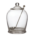Clear glass olive jar with matching lid and stainless steel serving spoon for stylish entertaining and antipasto presentation