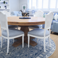 Olivia White Dining Chairs styled around the Mulhouse Round Dining Table in a bright Hamptons dining room with blue and white décor.