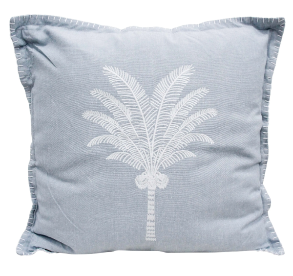 Chambray blue cushion with white embroidered palm tree and whipstitched edging