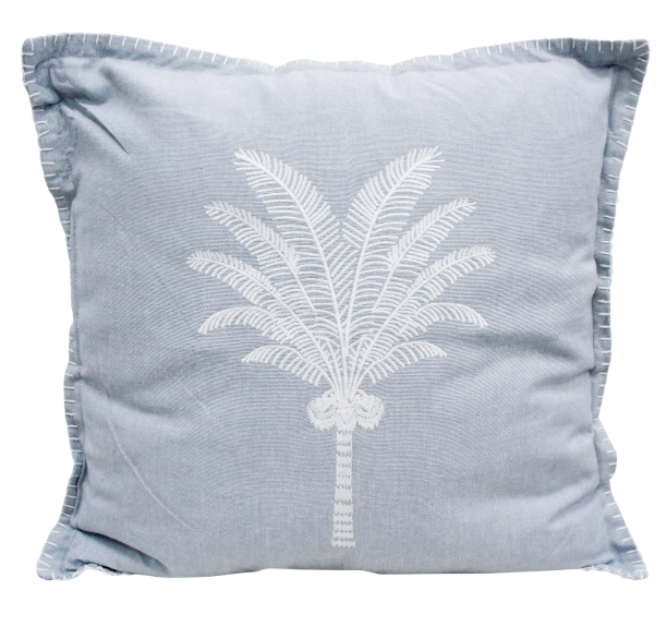 Chambray blue cushion with white embroidered palm tree and whipstitched edging