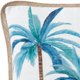 Close-up detail of the Palmy Blue Mirage Cushion showing painterly blue palm tree print and natural woven lattice trim on a white cotton cover.