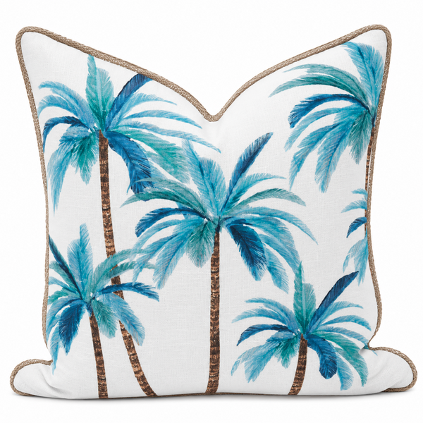Palmy Blue Mirage Cushion featuring tropical blue palm tree artwork on a white cotton cushion with natural woven lattice edging.
