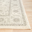 Close-up of the Parker White Rug highlighting the distressed floral border and textured pile