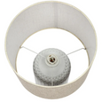 Patronga ceramic table lamp creating soft ambient lighting in a Hamptons-inspired bedroom or living room.
