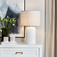 Coastal style Patronga table lamp styled in a neutral interior with textured ceramic base and linen-look shade.
