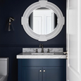 Porthole Mirror White styled above a navy vanity with marble benchtop in a sophisticated Hamptons-inspired bathroom.