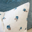 Close-up of Posey Blue Floral Cushion showing petite blue floral print and soft white fabric