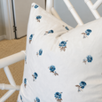 Posey Blue Floral Cushion 45cm styled on a white chair in a classic blue and white interior
