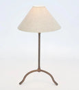 Bronze iron table lamp with linen shade in French country style, featuring a hand-beaten base and conical shade.