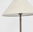 Bronze iron table lamp with linen shade in French country style, featuring a hand-beaten base and conical shade.