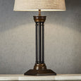 Elegant quad stem table lamp creating warm ambient lighting in a luxury living room