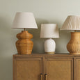 Close-up detail of the Rimmel lamp's ridged white ceramic base with matte gold accent.