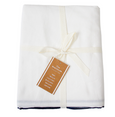 Folded Riviera Tablecloth White Navy crafted from cotton with classic navy trim and coastal styling appeal