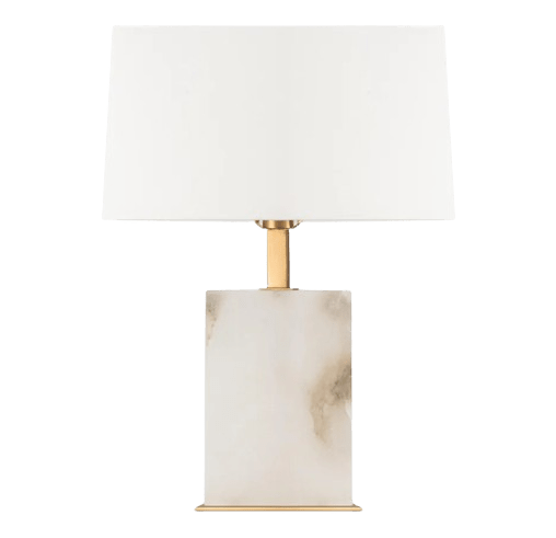 Roco alabaster table lamp with brass-finished frame and frosted white shade styled in a luxury living room

