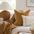 Rodeo Luxury Throw Caramel styled with matching caramel cushion on a white Hamptons sofa