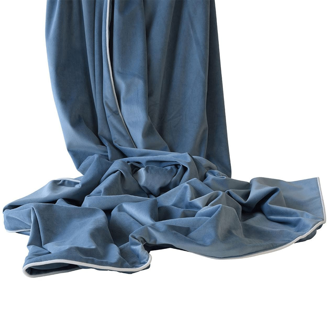 Ocean blue velvet throw with white piping draped softly, showcasing smooth texture and luxurious finish