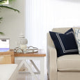 Silver mirrored tray styled on a side table with candle and coastal decor