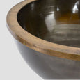 Close-up of Round Footed Ice Bucket showing the antique brass rim and dark aged metal bowl interior.