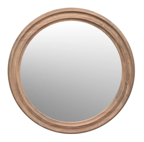 Round wall mirror displayed above a console table in a stylish entryway creating light, space and a welcoming atmosphere
