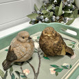 Rustic Birds Decorative Sculptures styled on a floral tray with eucalyptus foliage in a Hamptons-inspired interior display