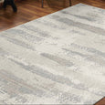 Sandbar Mist Rug styled in a contemporary living room with warm timber flooring, showcasing its soft ivory and grey abstract pattern.