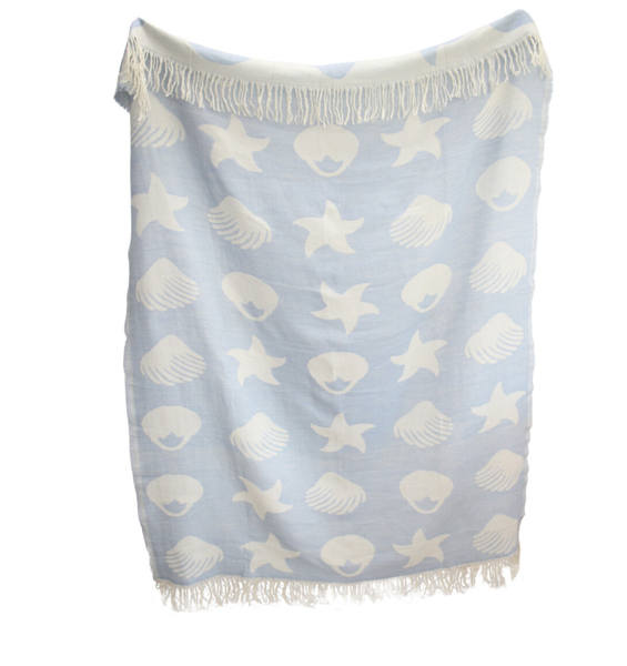 blue and white coastal throw with shell and starfish pattern and fringe edges