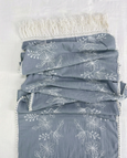 Soft denim blue table runner with white embroidered floral design folded view