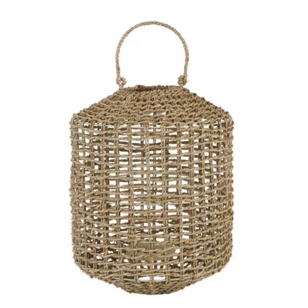 Natural woven seagrass lantern with carry handle and internal glass candle holder for relaxed coastal home styling.