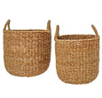 Handwoven natural seagrass tub baskets with handles, available in small and large sizes for coastal home storage or plant styling.