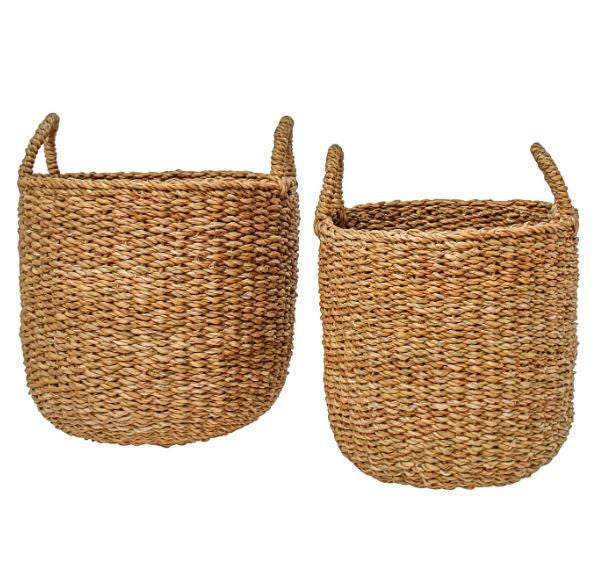 Handwoven natural seagrass tub baskets with handles, available in small and large sizes for coastal home storage or plant styling.