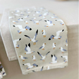 Coastal seagull tea towel styled on a neutral kitchen table setting