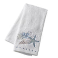 white seaside embroidered hand towel with blue starfish, shell and coral detail, soft cotton towel for coastal bathroom styling in Hamptons style home decor