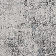 Close-up of the Shoreline Haze Rug showing the luxurious sculpted texture in ivory, grey and coastal blue tones.