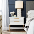 Off-white ceramic Smith table lamp adding warmth and texture to a living room or bedroom setting.
