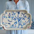 Songbird Serving Tray Cream displayed by hand showing scale and detailed blue bird illustration