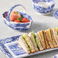 Blue Italian handled basket styled with fruit and tableware
