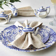 Spode Blue Italian teapot napkin ring styled with a linen napkin on a beautifully layered Blue Italian place setting.