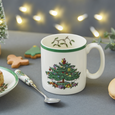 Spode Christmas Tree mug styled with Christmas cookies, festive lighting and holiday table décor creating a warm seasonal setting.