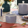 Spode Steccato covered sugar bowl styled with coordinating teapot and milk jug on an elegant blue and white table setting.