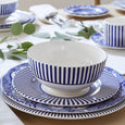 Spode Steccato rimless bowl layered with matching Steccato and Spode Blue Italian dinnerware on a beautifully styled blue and white table setting.