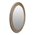 Decorative wall mirror reflecting natural light in a bright coastal living room