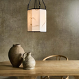 Stone Flower Chandelier illuminated above a natural timber dining table with ceramic vessels