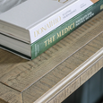 Close-up of the Vancouver console table's cross-sawn timber top with decorative books highlighting its natural texture.