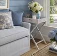 The Verandah Butlers Tray styled beside a blue and white striped sofa in a relaxed coastal living room, featuring soft natural light, woven textures, white hydrangeas, and timeless Hamptons-inspired décor.